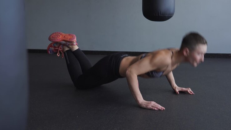 Woman doing push-ups in a gym