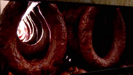 hanging smoked sausages in a processing facility