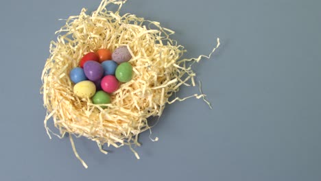 placing easter egg in straw nest