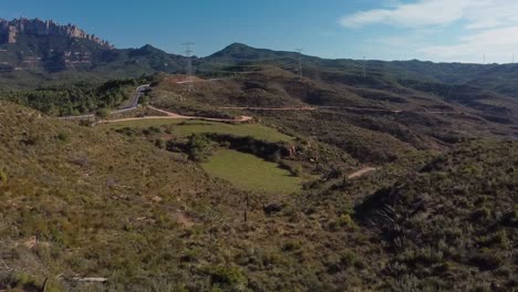 The-forest-of-the-crosses-in-montserrat,-marganell,-spain-on-a-sunny-day,-aerial-view