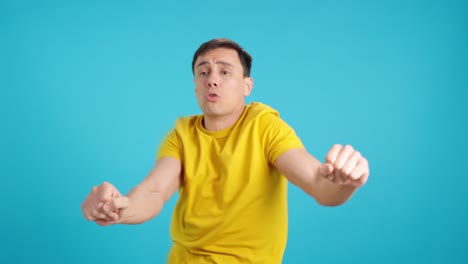 man in yellow t-shirt expressing emotions