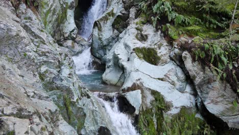 Tilt-down-water-course-of-narrow-limestone-slot-canyon-in-rainforest