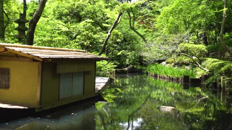 traditional japanese garden with lake and boat