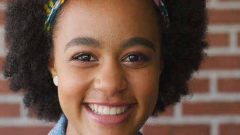 black woman, face and smile portrait with brick
