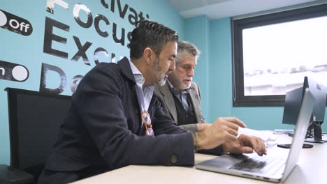 male managers discussing strategy in creative office