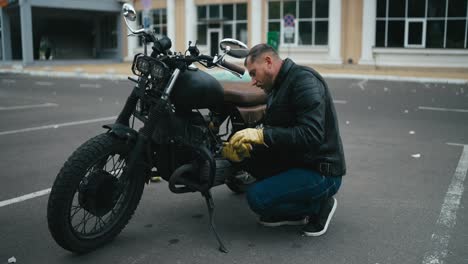 man working on a black custom motorcycle