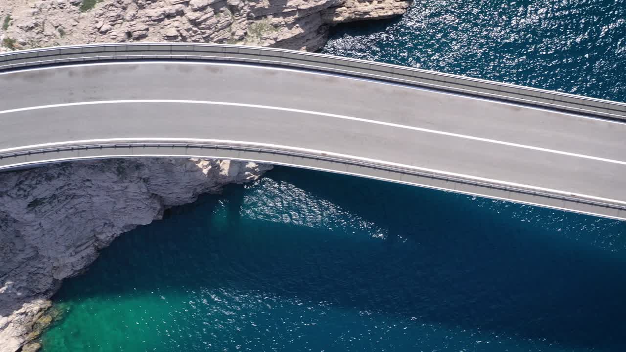Aerial dolly directly above Paški Most, bridge between Croatia and Pag Island