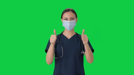 Happy-Indian-female-doctor-showing-thumbs-up-Green-screen