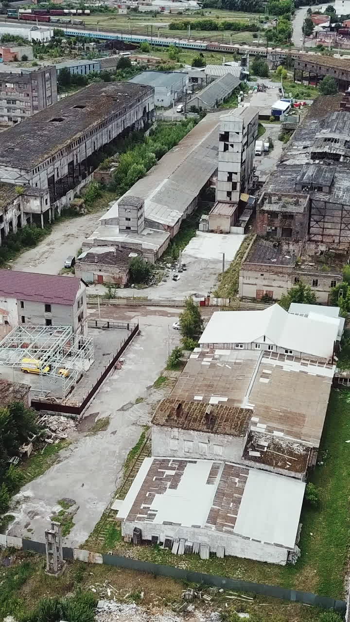 Aerial view of an abandoned industrial plant. Factory ruins.. Vertical video