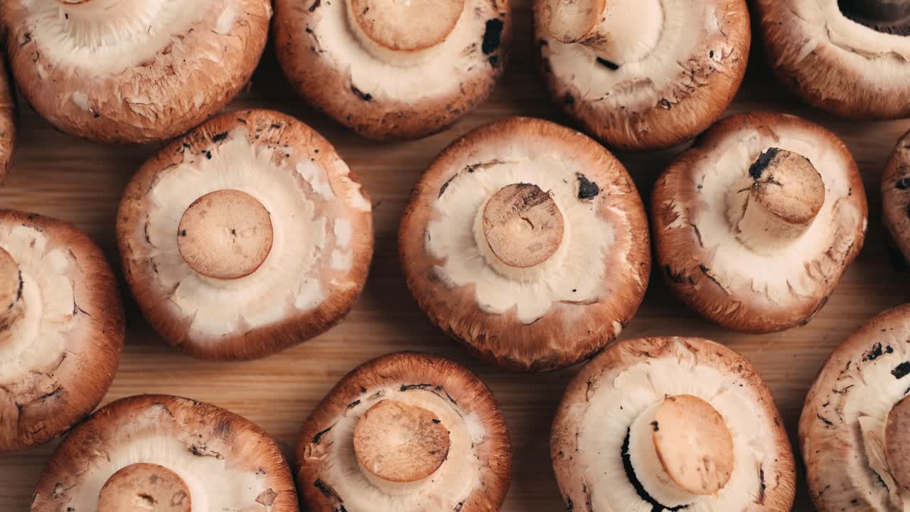 Fresh Brown Mushrooms on a Wooden Board