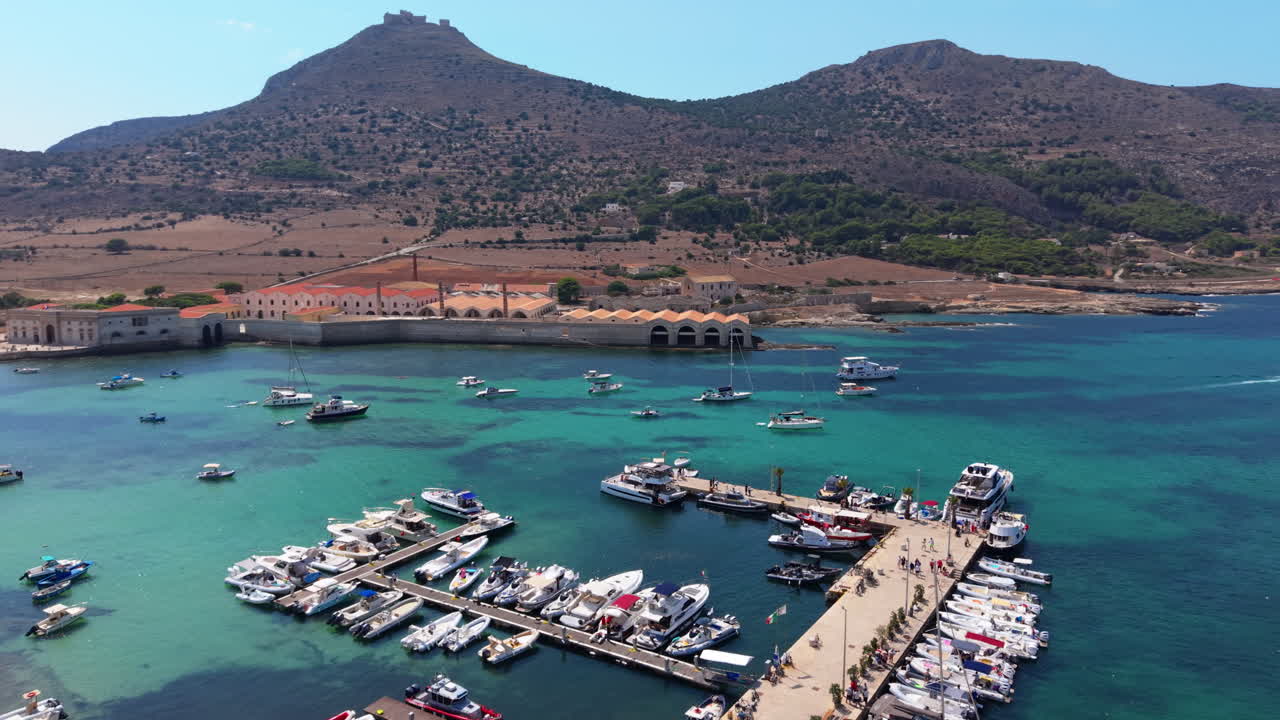 Stunning aerial view of Favignana harbor on a sunny day captures tranquility