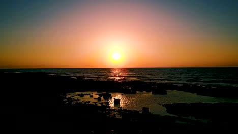 brightly colored sunset over the calm mediterranean sea. drone point of view .