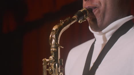 close up view of latin man playing sax during live music perfomance 2