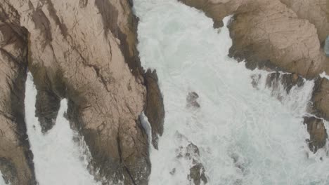 aerial view of a small inlet being hit by the waves