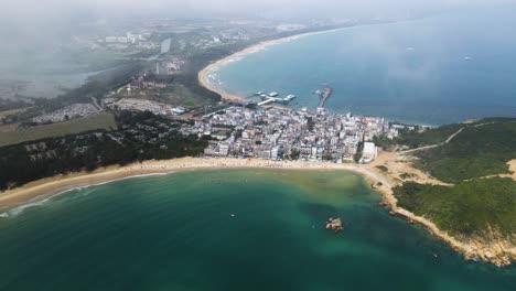 sanya beach on hainan island, south china - aerial bird's eye view with clouds