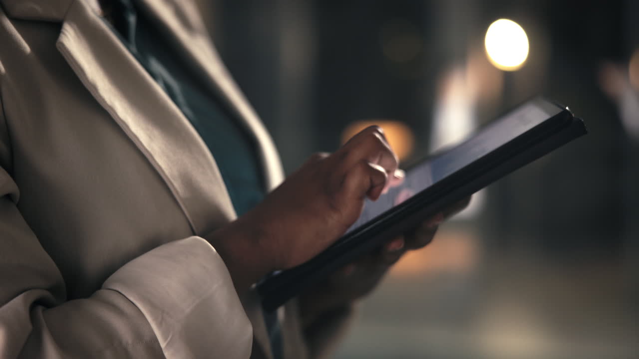 Close-up of a Person's Hands Using a Digital Tablet