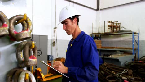 male engineer maintaining stocks in workshop 4k