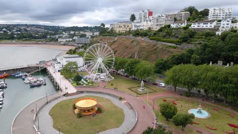 ferris wheel for tourists on vacation to resort town of torquay, england - aerial