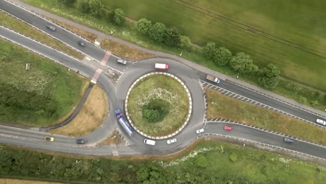 4K-aerial-ascending-footage-of-a-junction-on-the-A64-near-Scarborough-with-cars-and-trucks-and-green-countryside