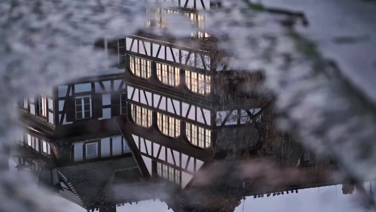 Reflection of a Half-Timbered Building in a Puddle