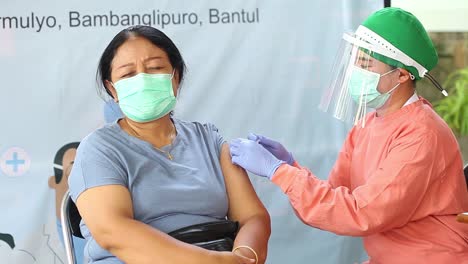 yogyakarta, indonesia - feb 15, 2021 : female health workers at a hospital are being injected with the corona virus vaccine
