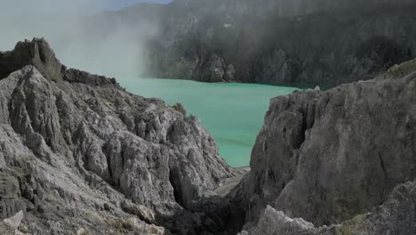 Drone-flies-into-volcano-crater,-capturing-acid-lake