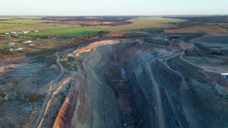 large open-pit gold mine for mineral extraction in industrial and agricultural area