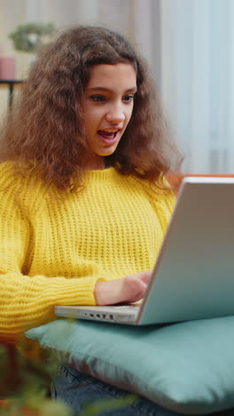 Amazed-teen-girl-use-laptop-computer,-receive-good-news-message,-shocked-by-victory,-celebrate-win