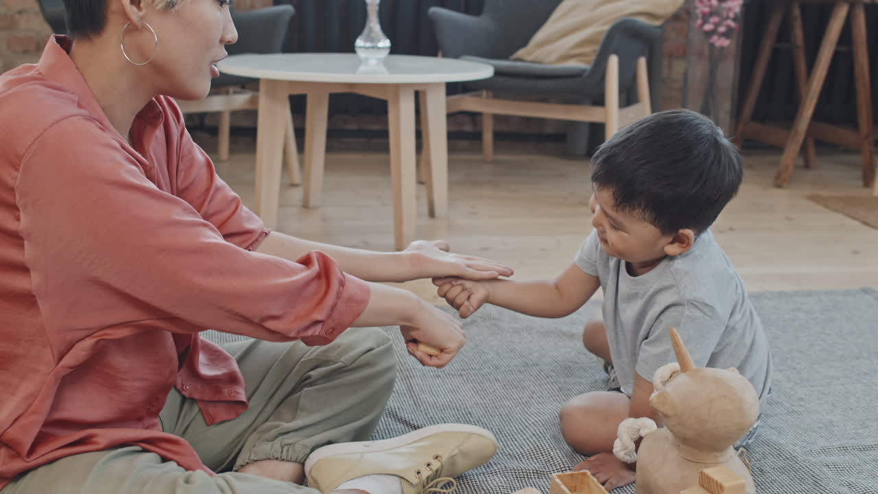 Asian Boy Playing with Mom in Living Room