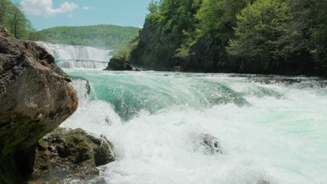 A-waterfall-of-a-pure-wild-river-located-in-a-green-rainforest