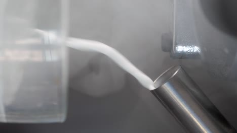 pouring liquid nitrogen into a metal tube