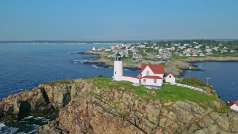 a drone view captures a dynamic flythrough of nubble lighthouse and its adjacent building at york beach, offering a unique perspective of the iconic landmark