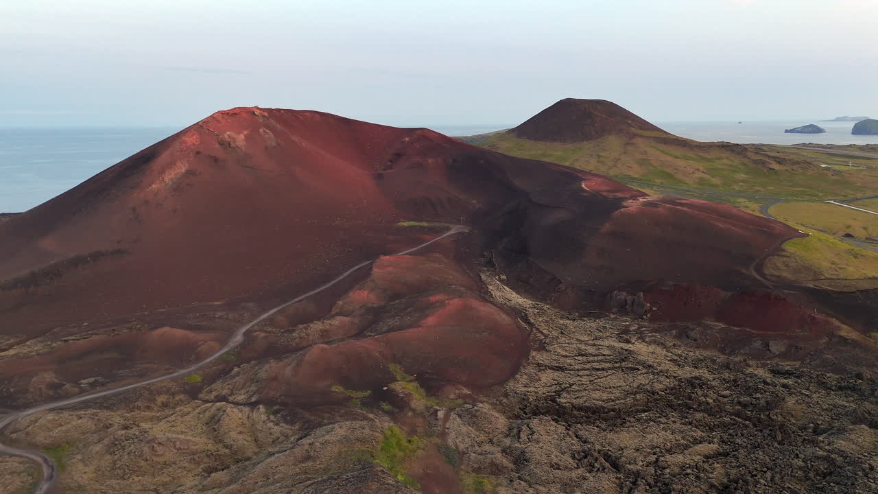 Cinematic aerial drone view of volcanic craters and lava fields in Iceland highlands, barren volcanic desert, rugged mountains and dramatic Nordic landscape, nature and geology background