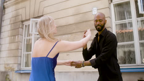 interracial couple dancing salsa in the old town street 3