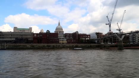 london offices under construction near the thames and heading under the millennium bridge