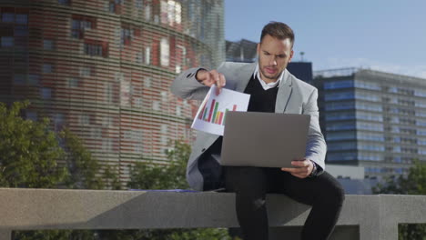 Businessman-having-video-chat-on-laptop-at-street.-Freelancer-using-computer