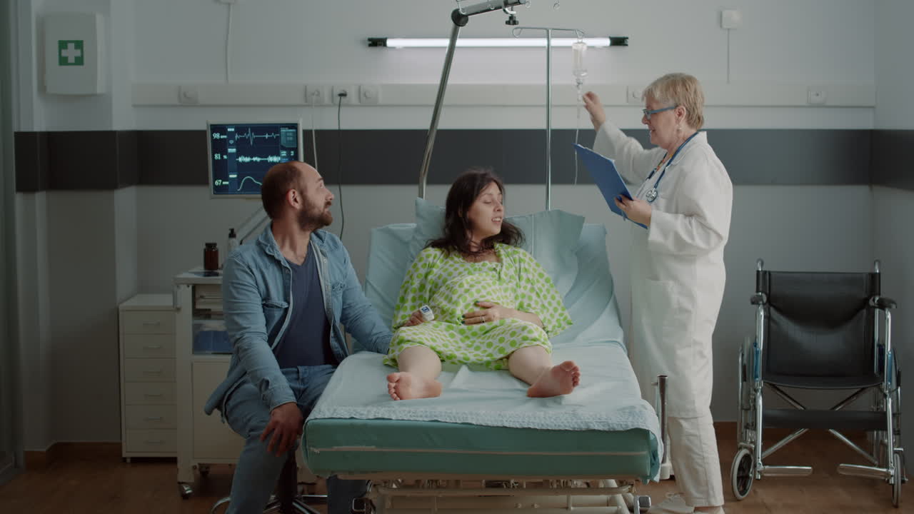 Caucasian pregnant person getting advice from doctor