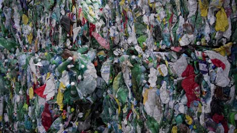 a massive stack of compressed plastic bottles and various waste