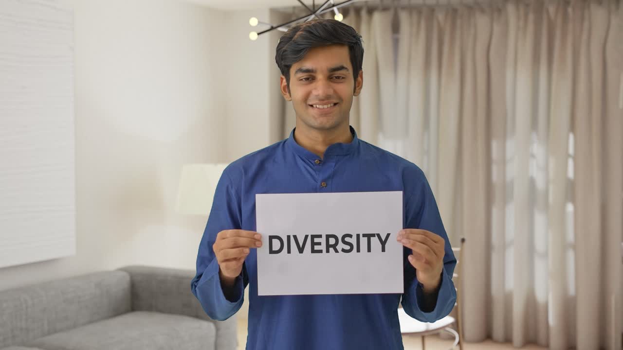 Happy Indian boy holding DIVERSITY banner
