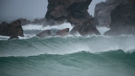 Perfect-set-of-waves-breaking-along-a-rocky-coastline-with-a-strong-offshore-breeze-in-Scotland