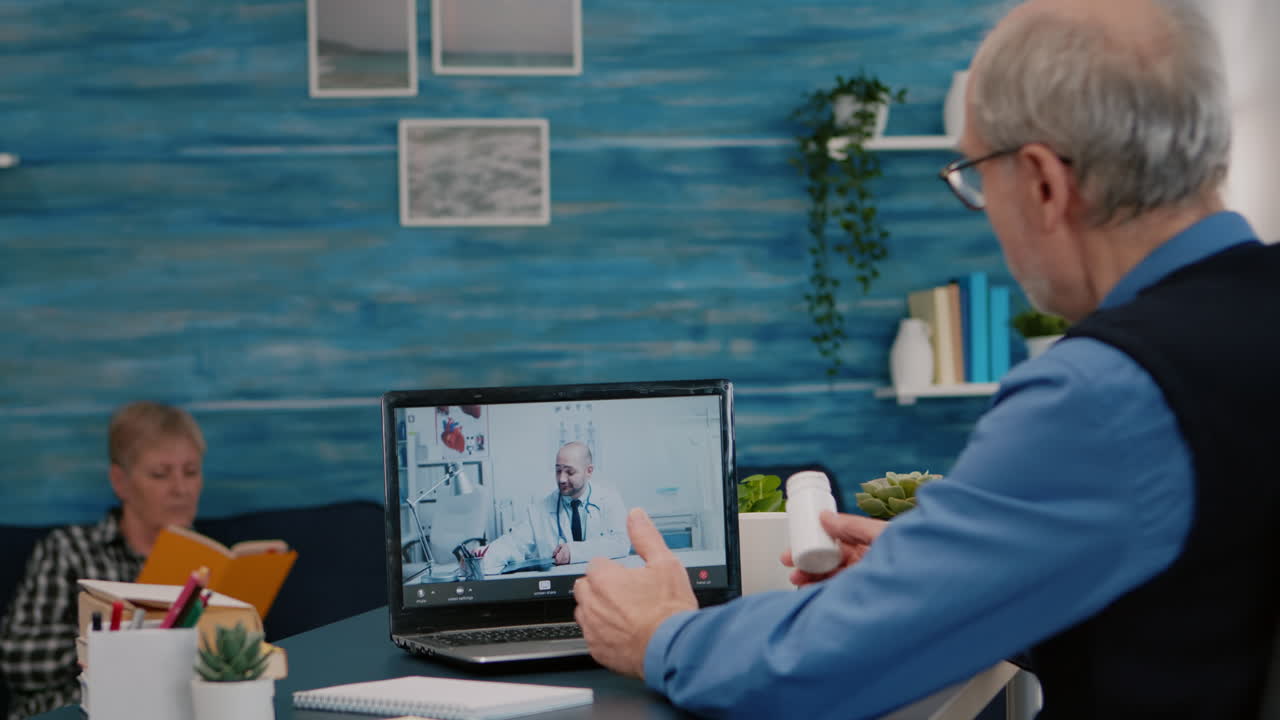 Remote doctor using webcam prescribing medicine to sick aged man