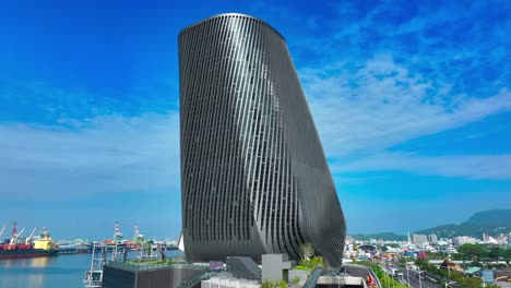 Aerial-shot-showing-modern-architecture-of-Kaohsiung-Cruise-Terminal-against-blue-sky