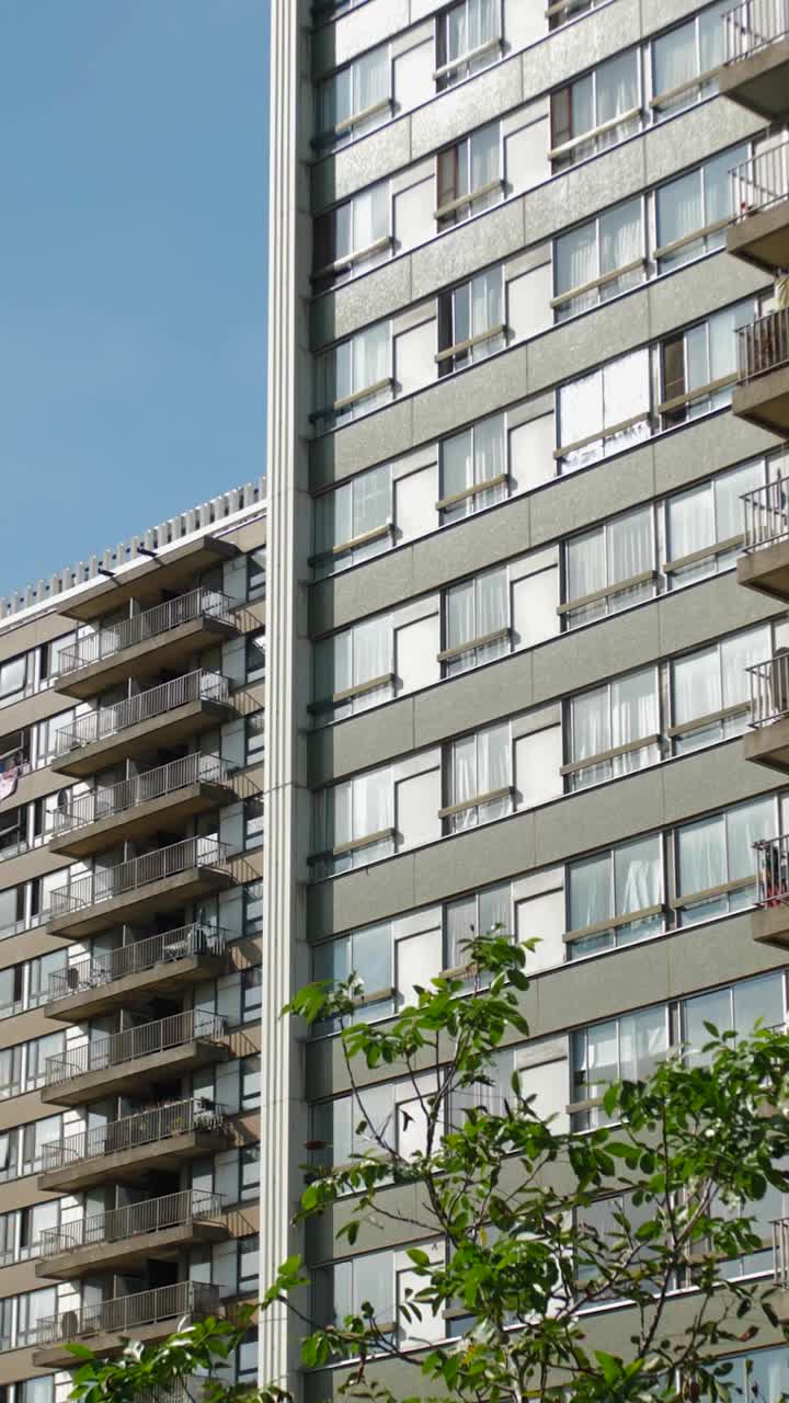 Vertical shot of urban residential towers with balconies and window details