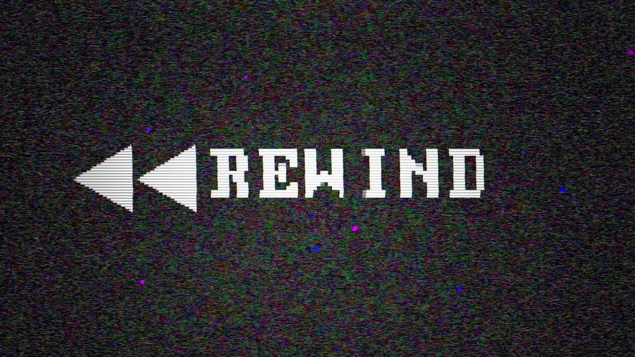 Vintage monitor displays "Rewind" icon glitching on retro VHS screen