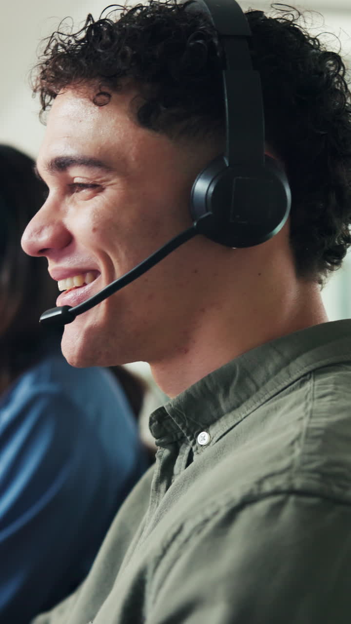 Smiling Young Man Wearing Headset in Call Center
