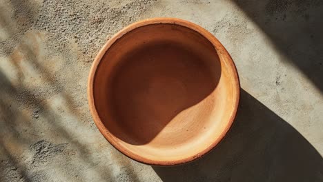 empty clay bowl on a grey background