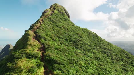 lush greenery covers le pouce mountain under a sunny sky, aerial view