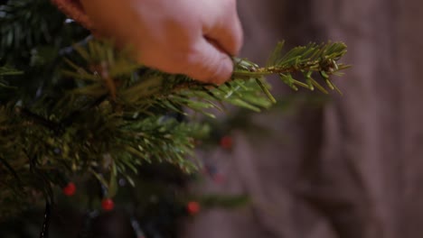 Removing-christmas-heart-decor-and-stripping-pine-leaf,-closeup