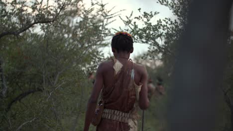 a native tribesman coming into focus as he walks away from the camera