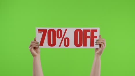 70 percent off advertisement inscription on paper sheet in womans hands on chroma key. slow motion